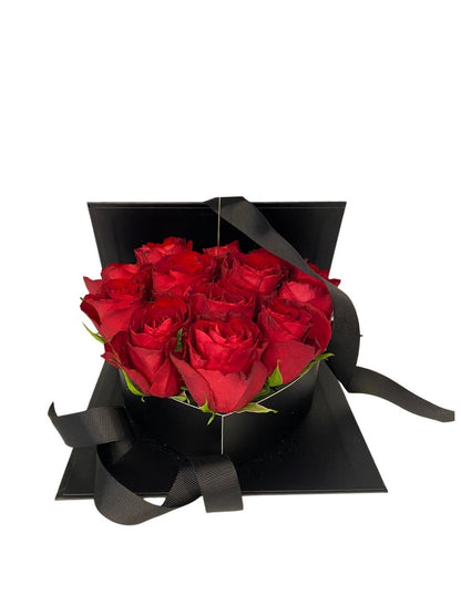 Black box with red roses on a white background