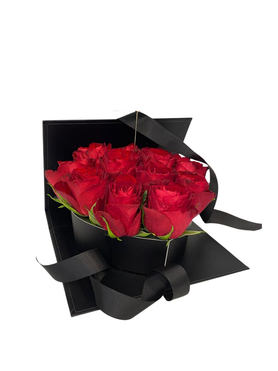 Bouquet of red roses wrapped in black paper with a bow on a white background