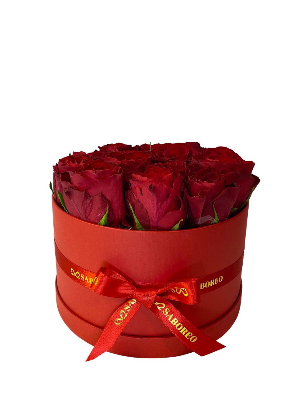 Red roses in a box with a red ribbon on a white background